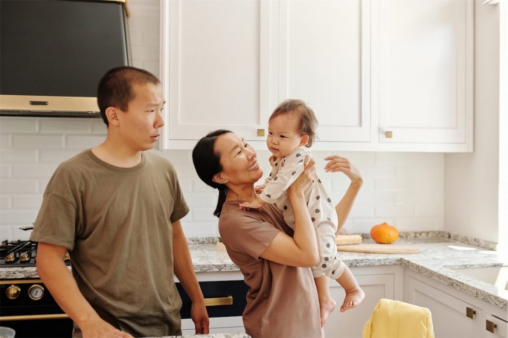 A family in the kitchen looking happy that their TDSR meets the 60% limitation