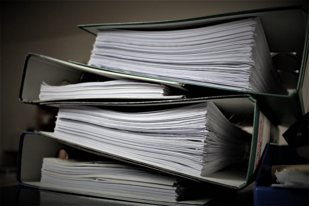  A stack of files and paperwork showing overdue payments to resolve with a Debt Consolidation Plan in Singapore