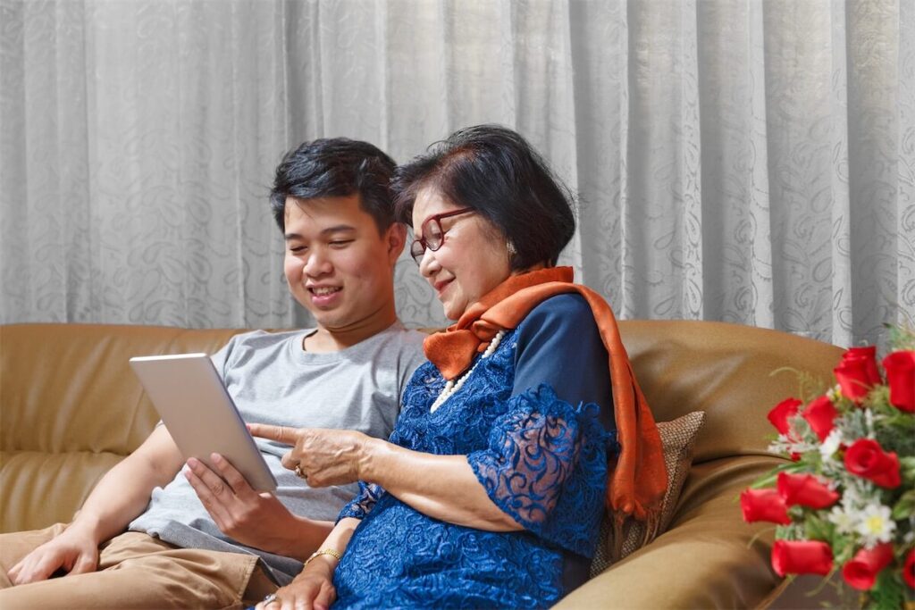 Mother and son looking at stimulus packages given to them to help with the home loan in Singapore amid the COVID-19 pandemic