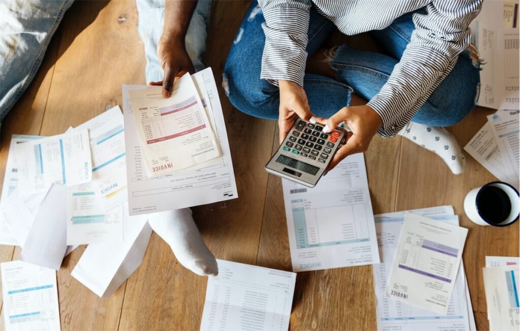 Couple managing their bills and calculating whether they can afford an EC in Singapore