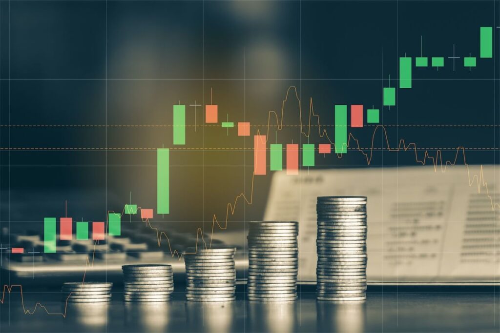 Image of a stack of coins in front of a growing stock market chart to the cycle of interest rates in home loans in Singapore